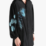 Black shirt worn by a person, showing the shirt's fit