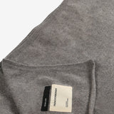 Close up of the brown blanket, showing texture of the fabric