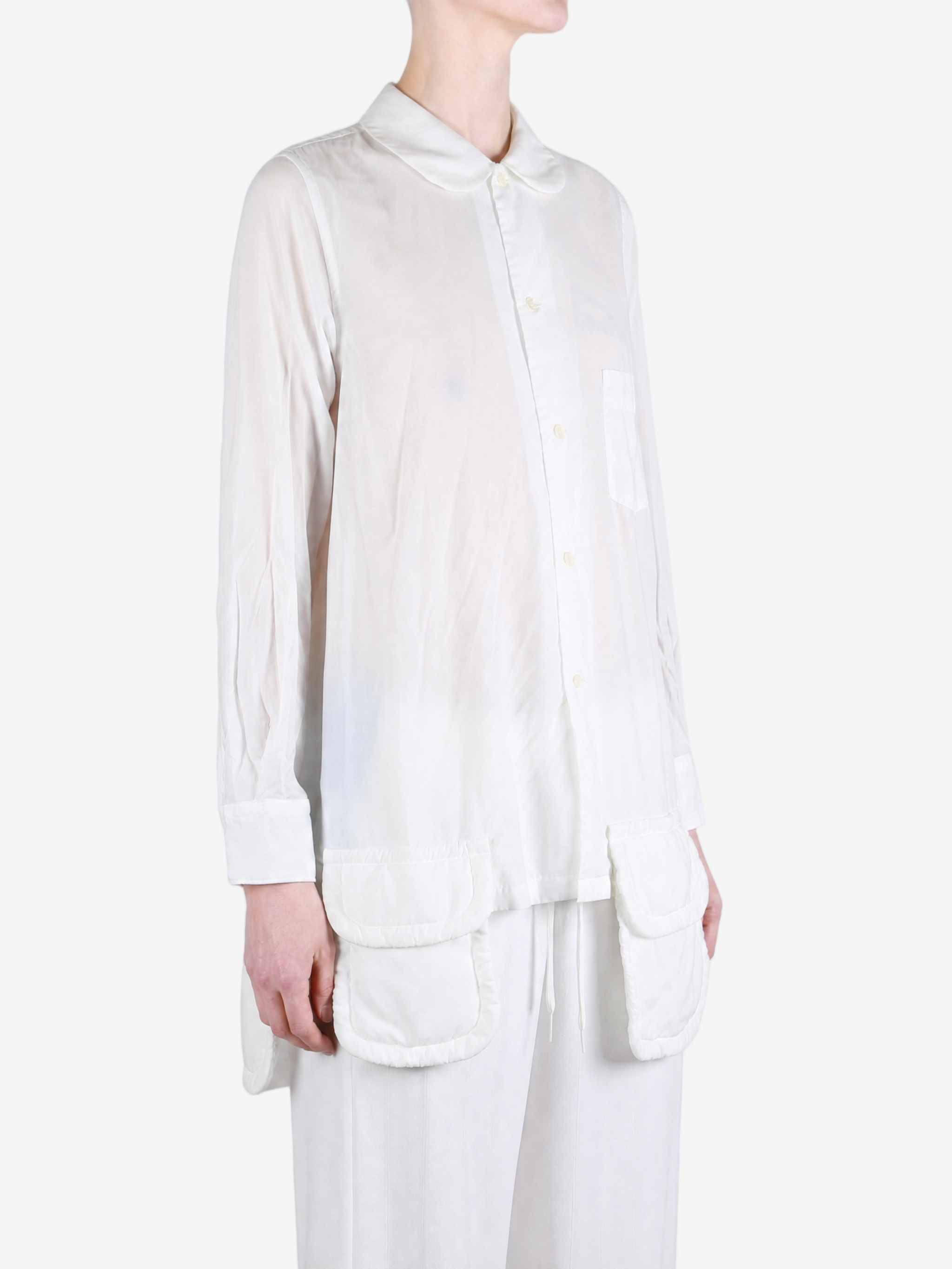 White shirt worn by a person, showing the shirt fit