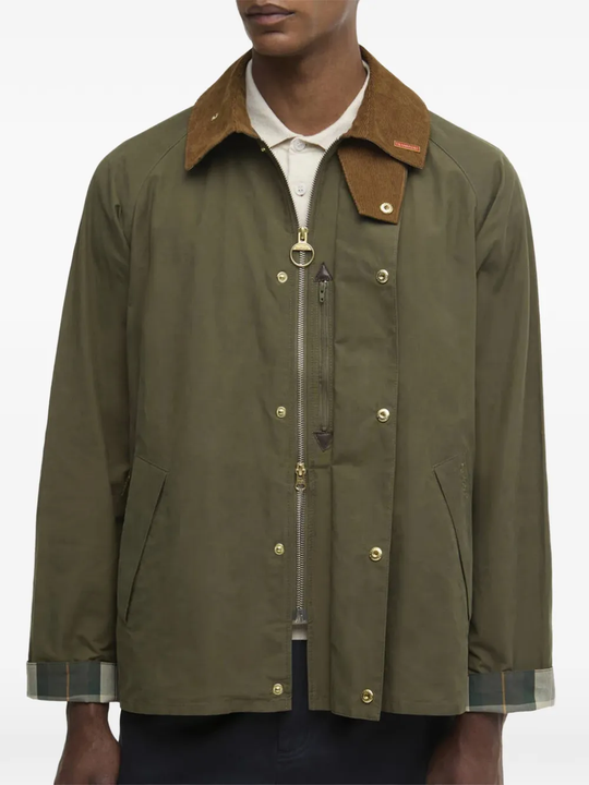 Green jacket worn by a person, showing the jacket's fit