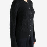 Black knitwear worn by a person, showing the knitwear fit