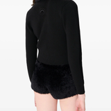 black knitwer worn by a person, showing the knitwer fit