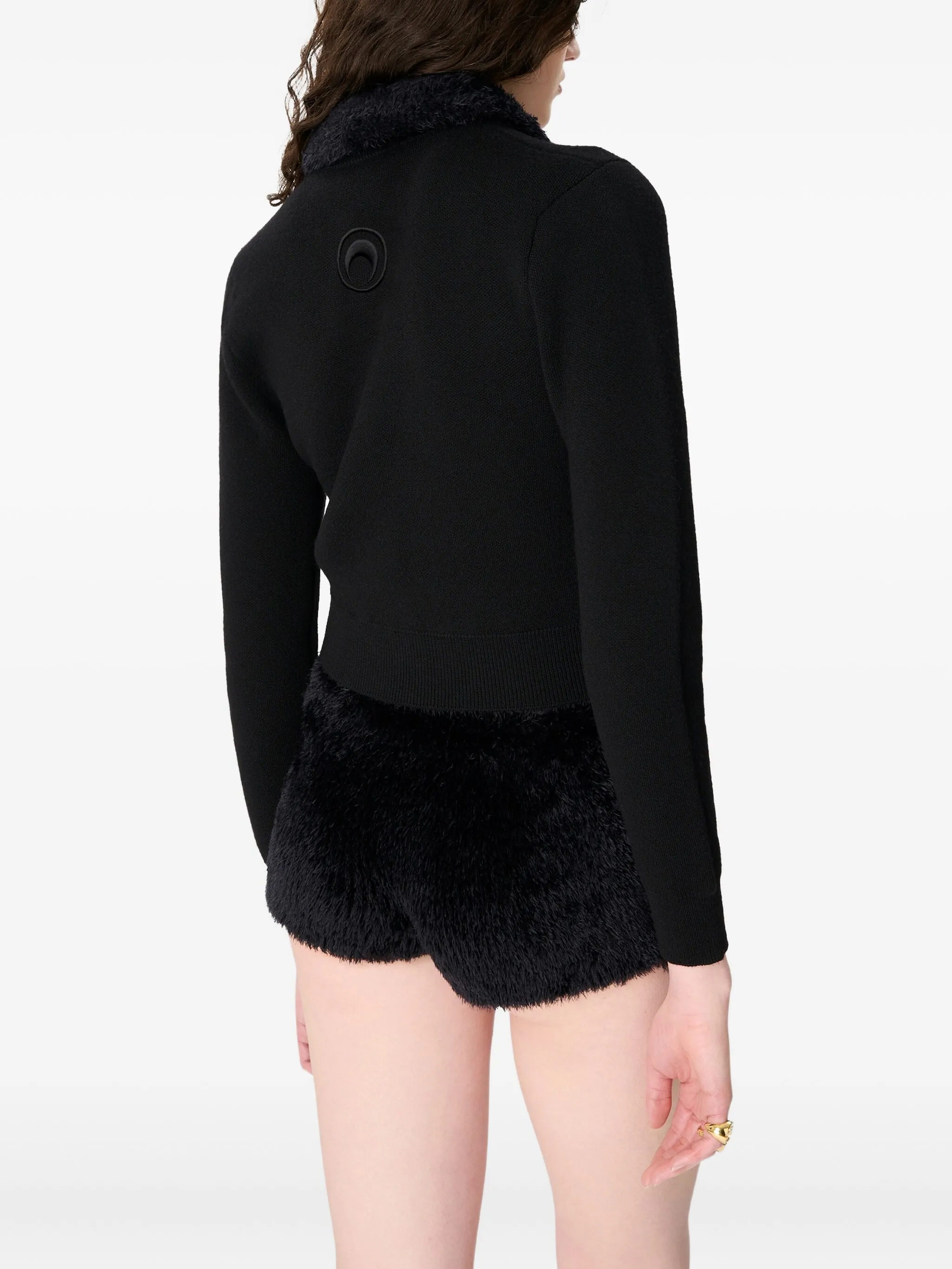 black knitwer worn by a person, showing the knitwer fit