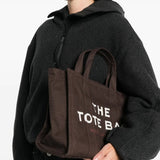 Brown bag, carried by a person, showing the bag's size