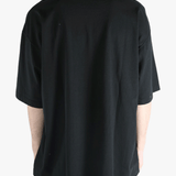 Black t-shirt worn by a person, showing the shirt's fit