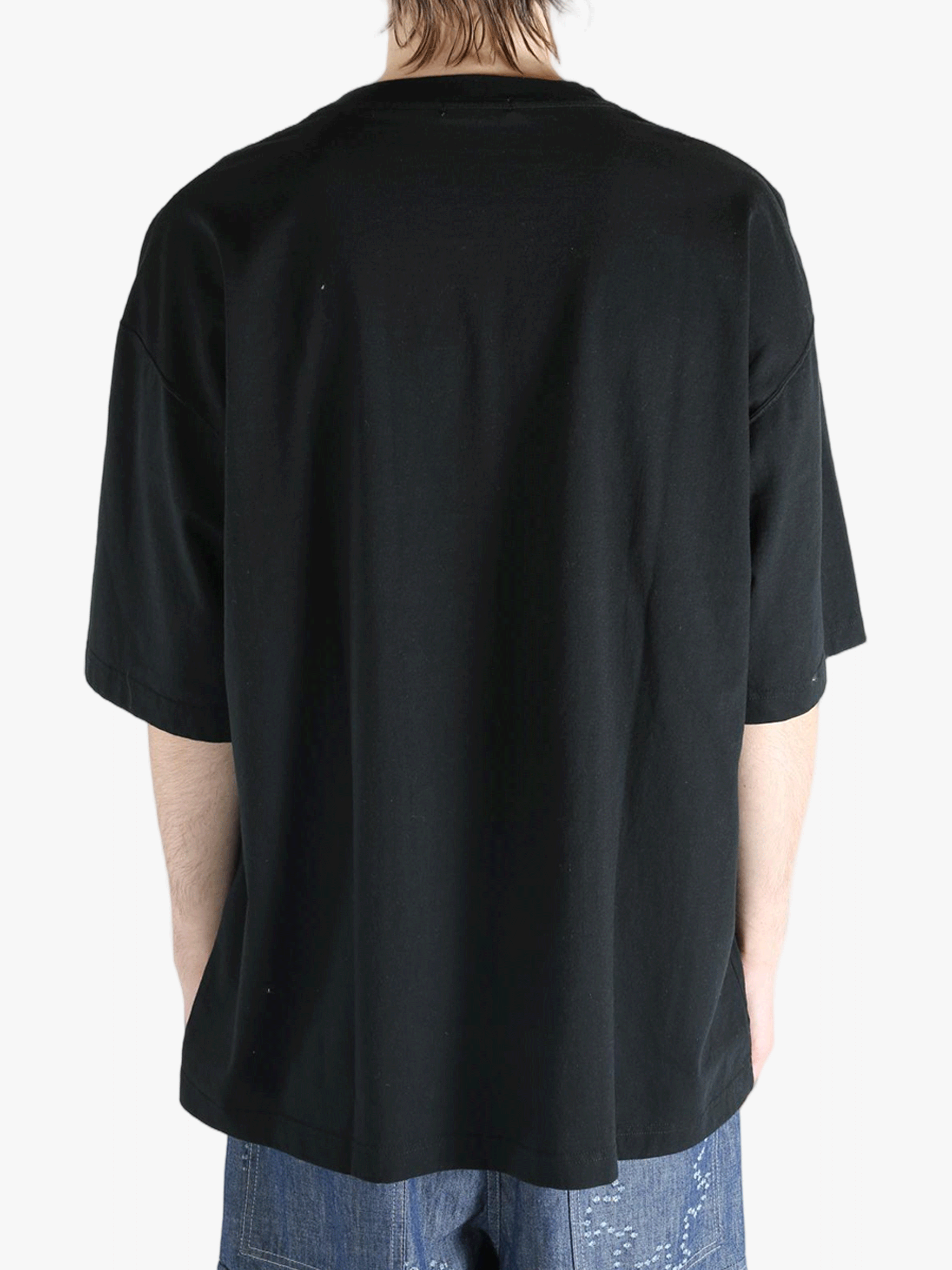 Black t-shirt worn by a person, showing the shirt's fit