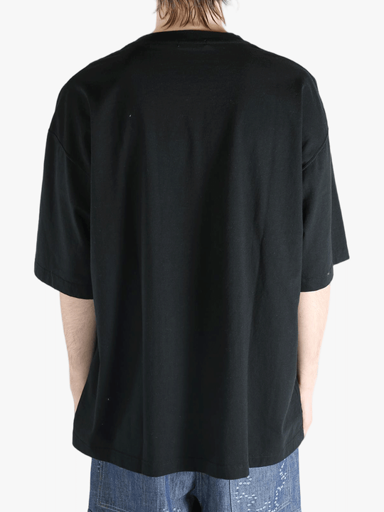 Black t-shirt worn by a person, showing the shirt's fit