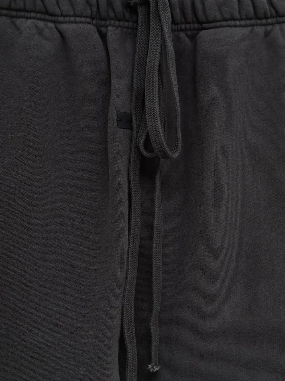 Close up of the grey pants, showing texture of the cotton fabric