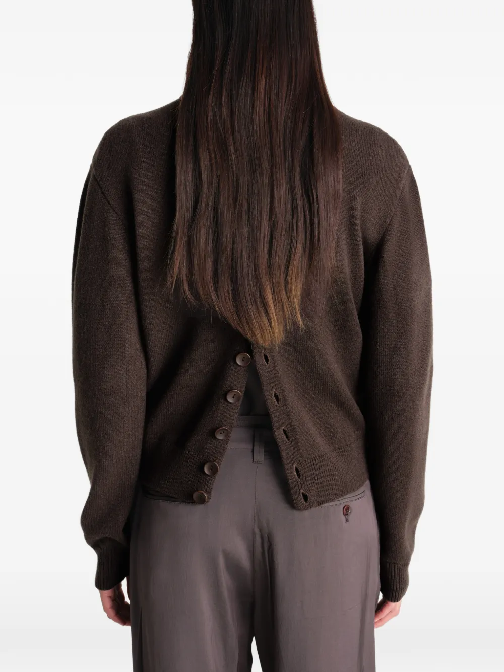 Brown knitwear worn by a person, showing the knitwear's fit