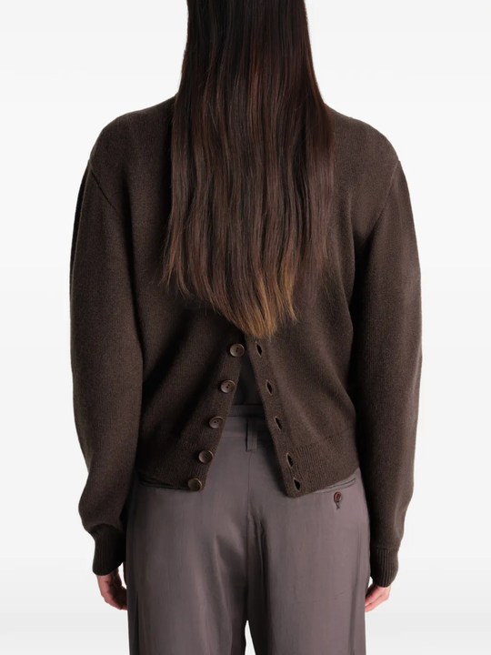 Brown knitwear worn by a person, showing the knitwear's fit