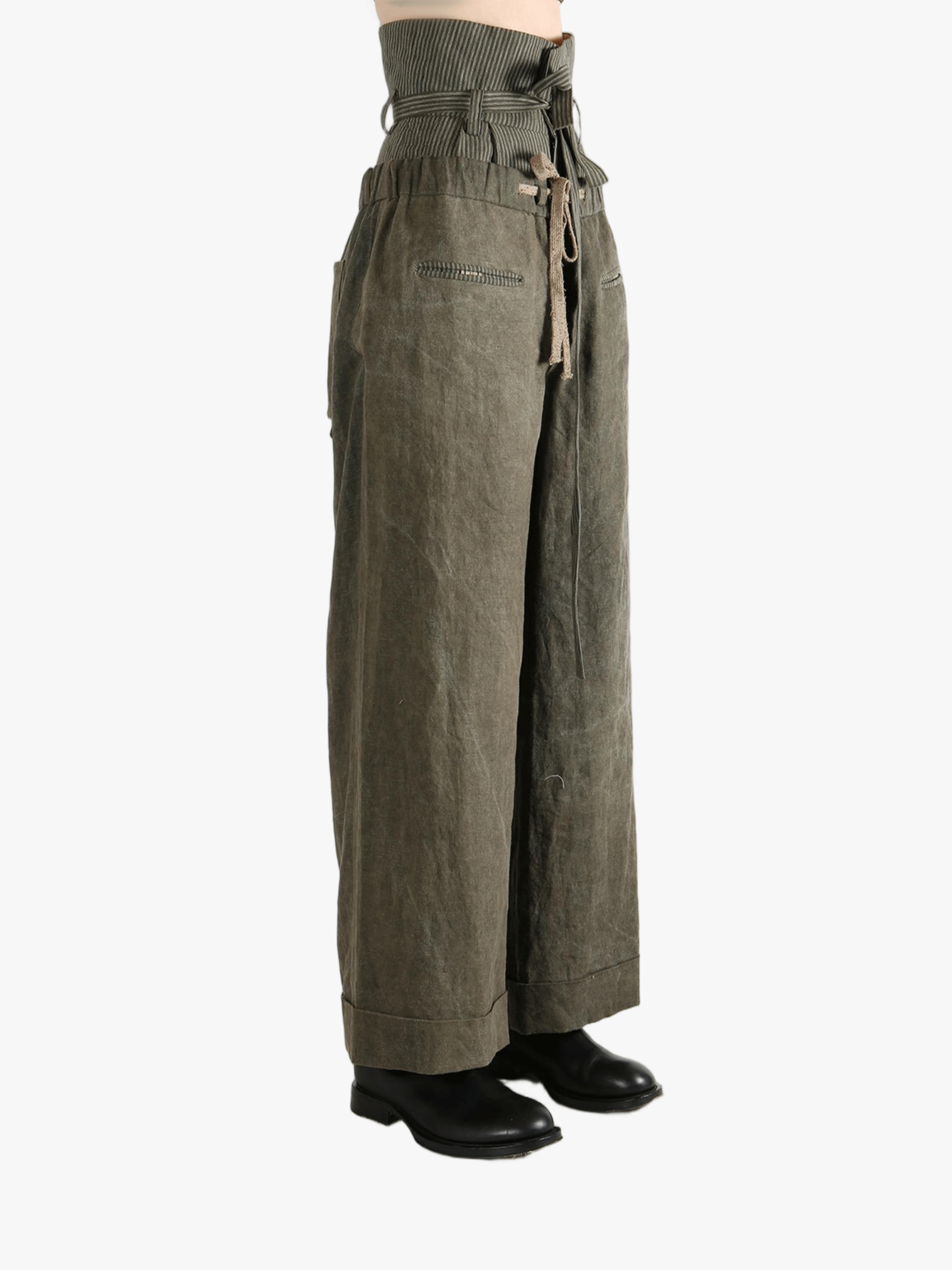 Green pants worn by a person, showing the pants' fit