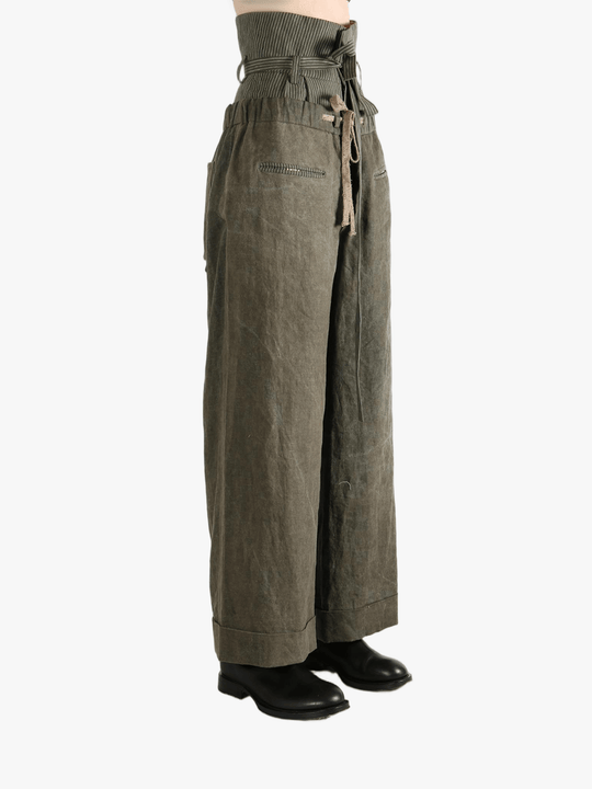 Green pants worn by a person, showing the pants' fit