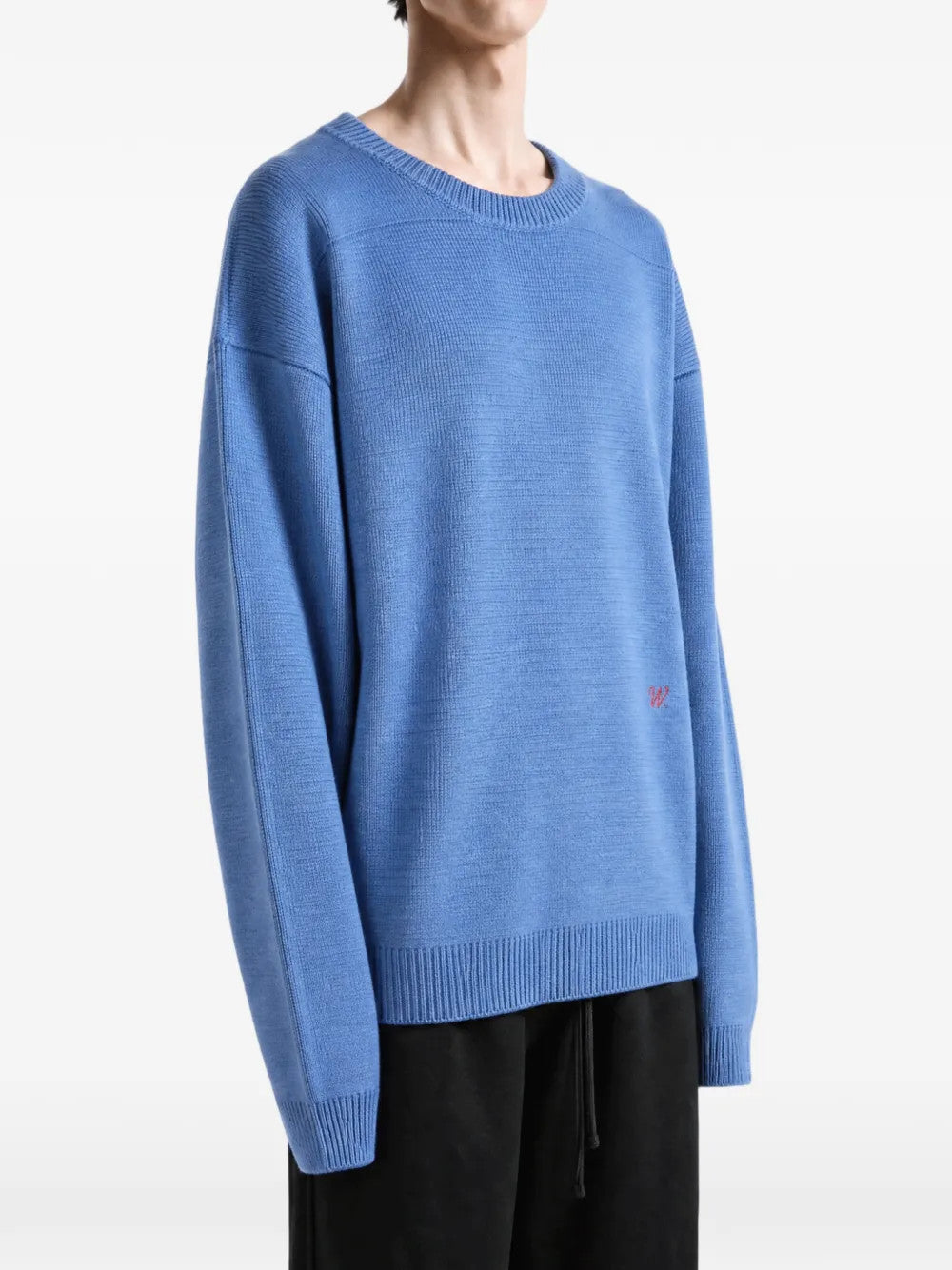 Blue knitwear worn by a person, showing the knitwear fit
