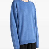 Blue knitwear worn by a person, showing the knitwear fit