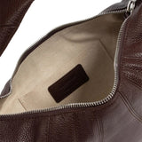Close up of the brown bag, showing texture of the leather fabric