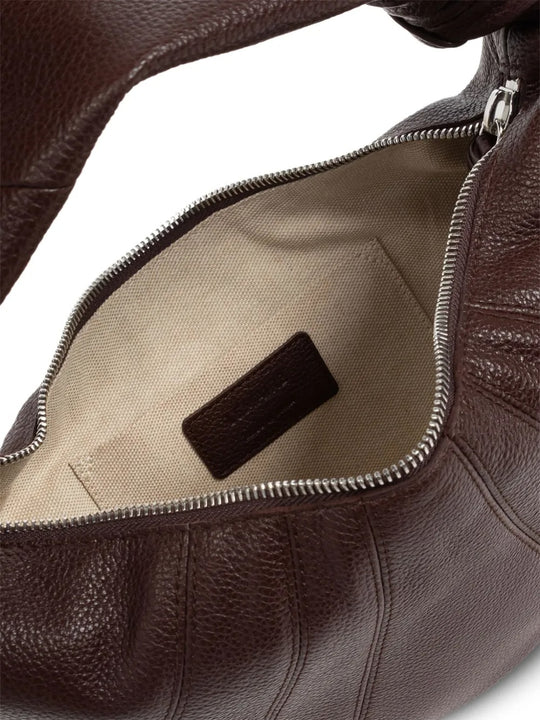 Close up of the brown bag, showing texture of the leather fabric