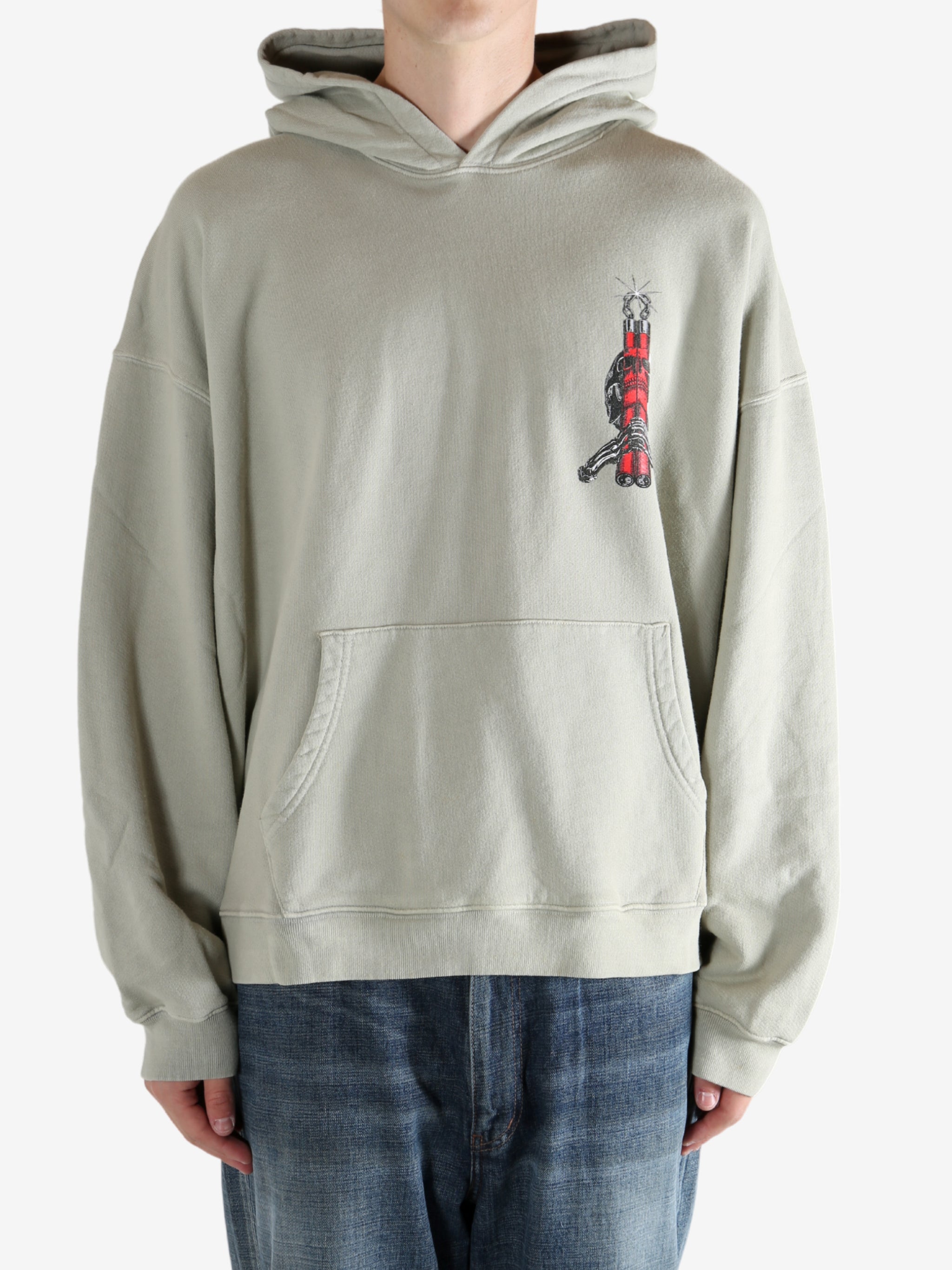 Grey hoodie worn by a person, showing the hoodie's fit