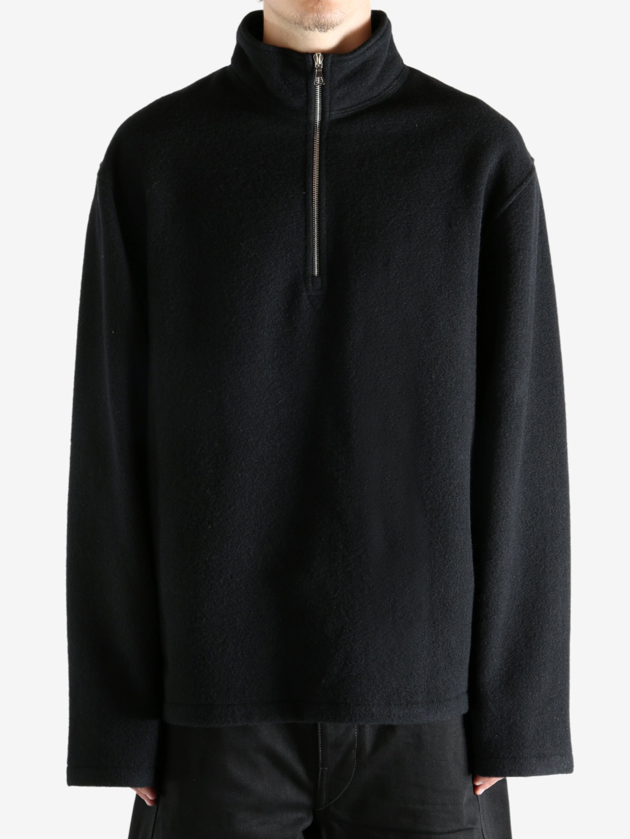 Black shirt worn by a person, showing the shirt's fit