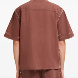 Brown shirt worn by a person, showing the shirt fit