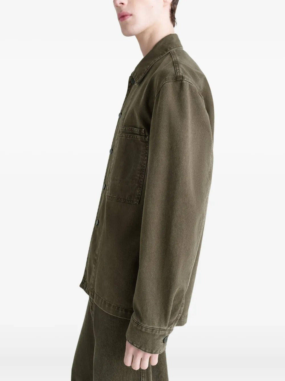 Green shirt worn by a person, showing the shirt's fit