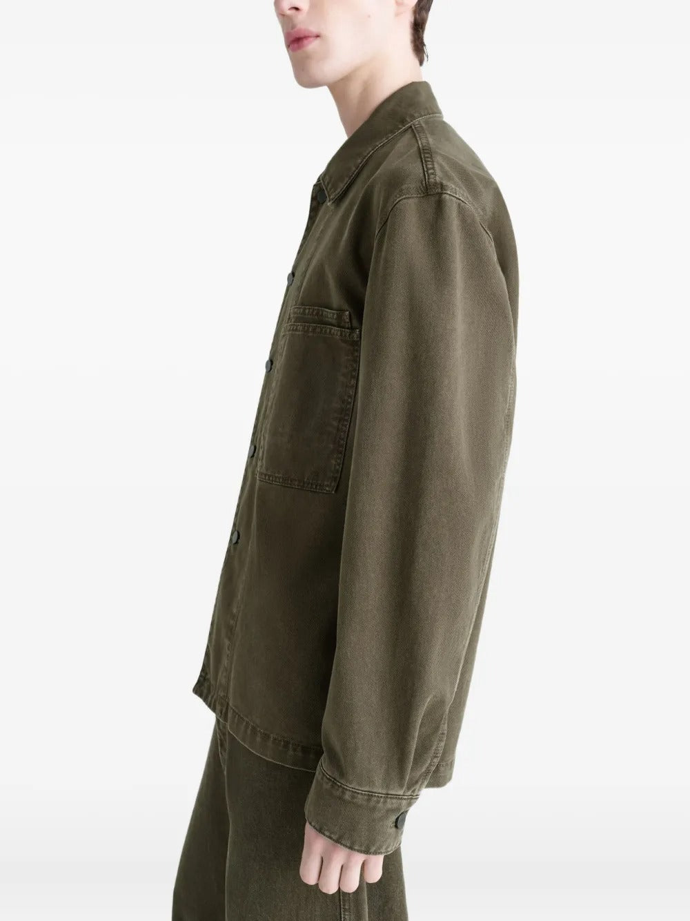 Green shirt worn by a person, showing the shirt's fit