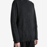 Black knitwear worn by a person, showing the knitwear fit