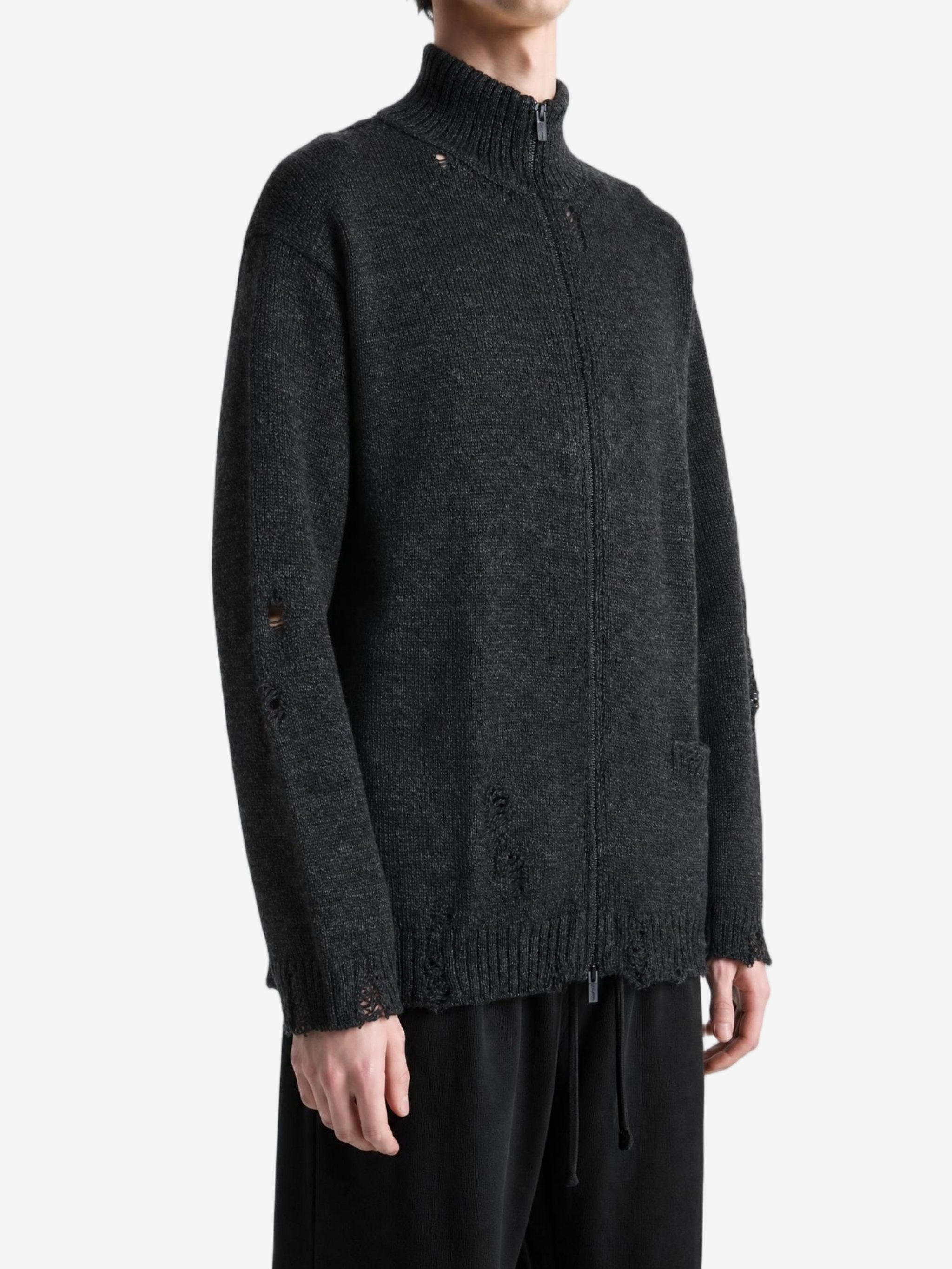 Black knitwear worn by a person, showing the knitwear fit