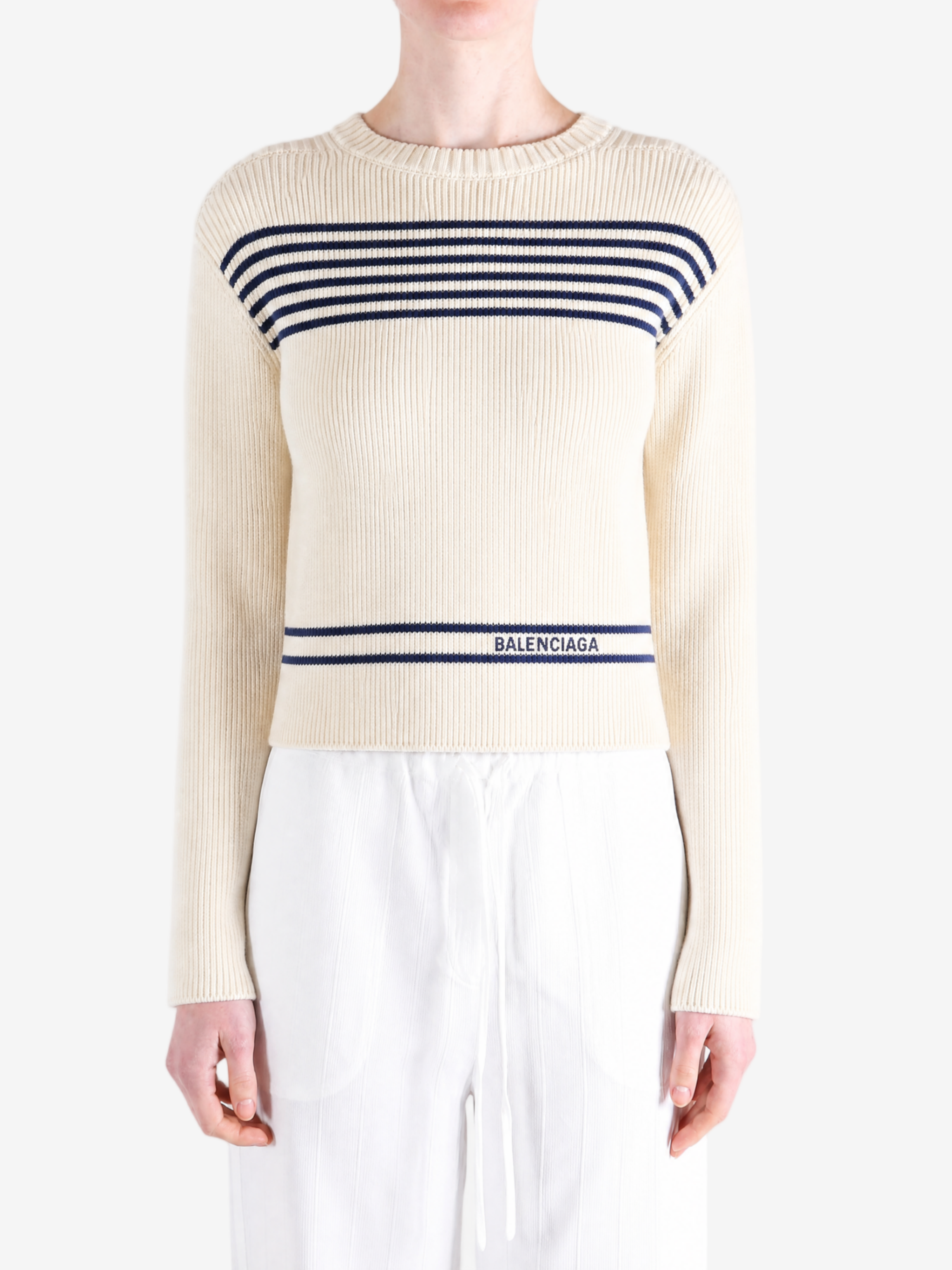 Tan knitwear worn by a person, showing the knitwear fit
