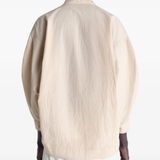 Tan top worn by a person, showing the top's fit