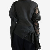 Black top worn by a person, showing the top's fit