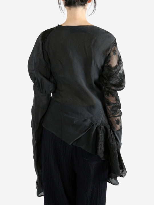 Black top worn by a person, showing the top's fit