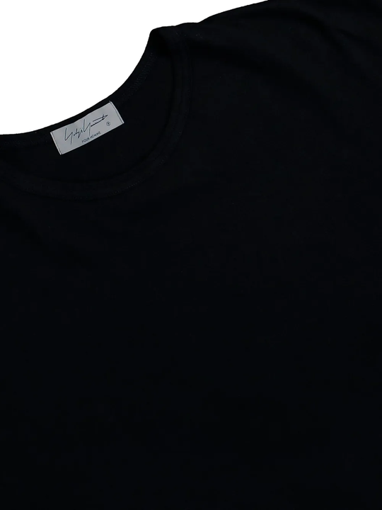 close up of black t-shirts, showing texture of the cotton fabric