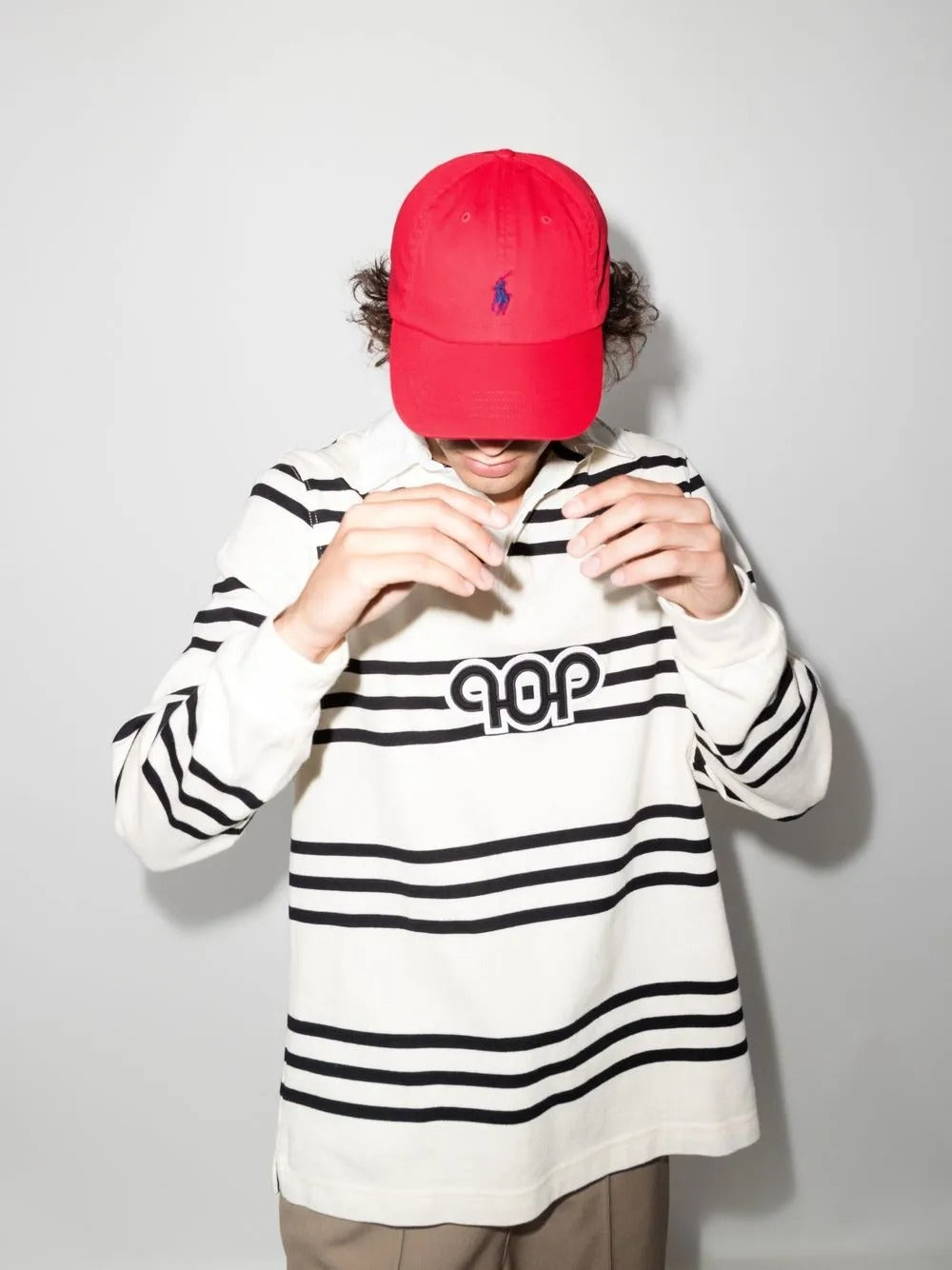 Red hat worn by a person, showing the hat's fit