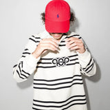 Red hat worn by a person, showing the hat's fit