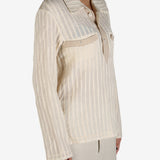 Tan shirt worn by a person, showing the shirt’s fit