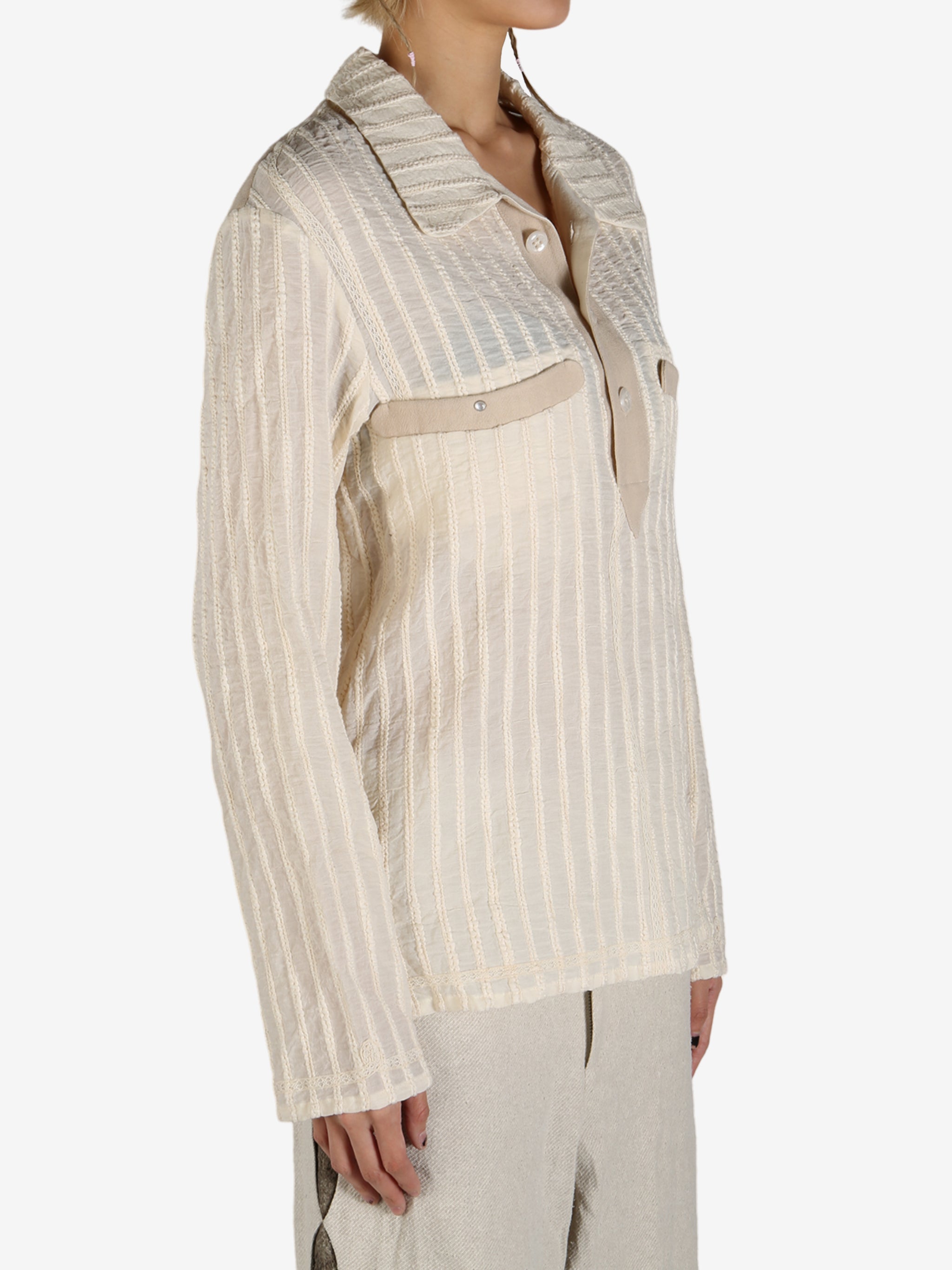 Tan shirt worn by a person, showing the shirt’s fit