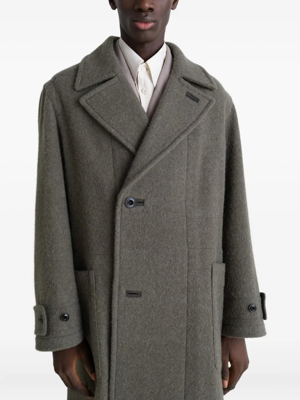 Grey coat worn by a person, showing the coat's fit