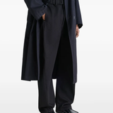 black loafers-mules worn by a person, showing the loafers-mules fit