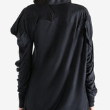 Black top worn by a person, showing the top's fit