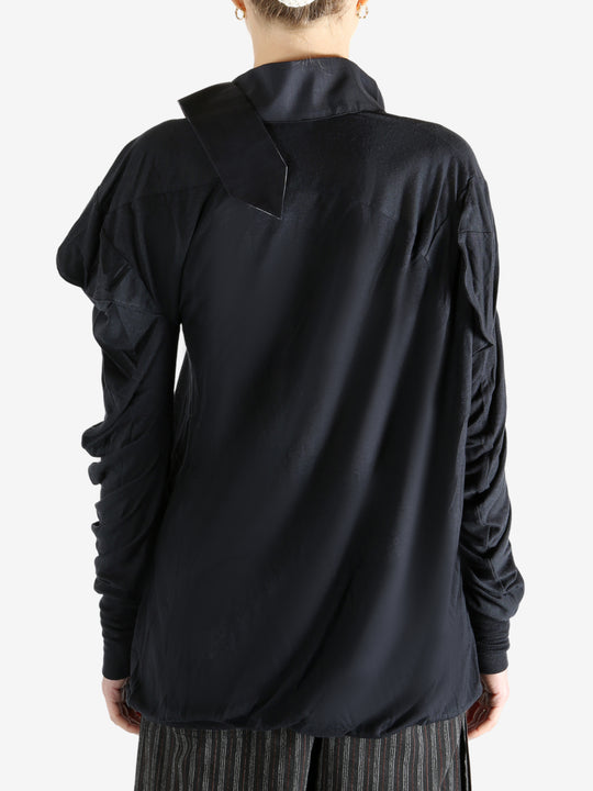 Black top worn by a person, showing the top's fit