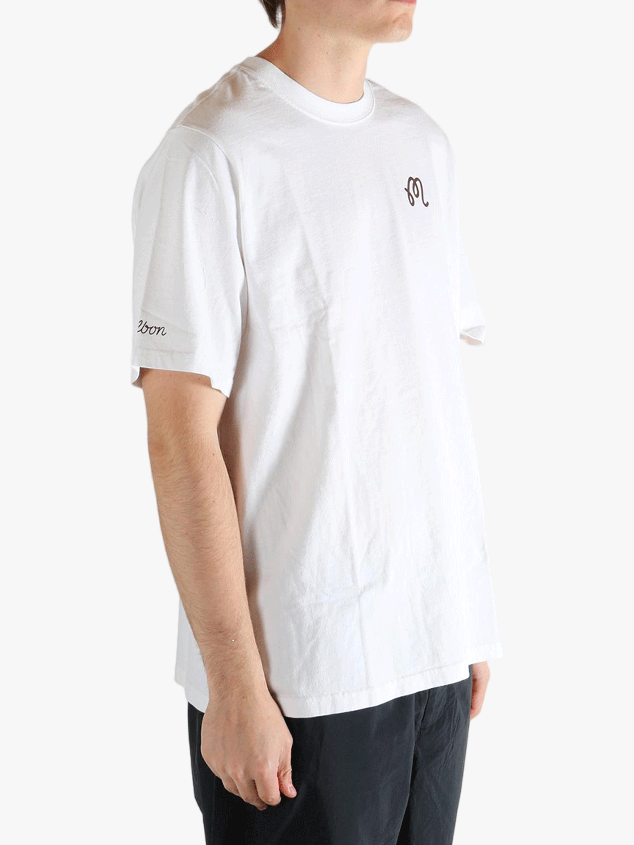 White t-shirt worn by a person, showing the t-shirt's fit