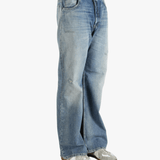 Blue jean worn by a person, showing the cow leather fit
