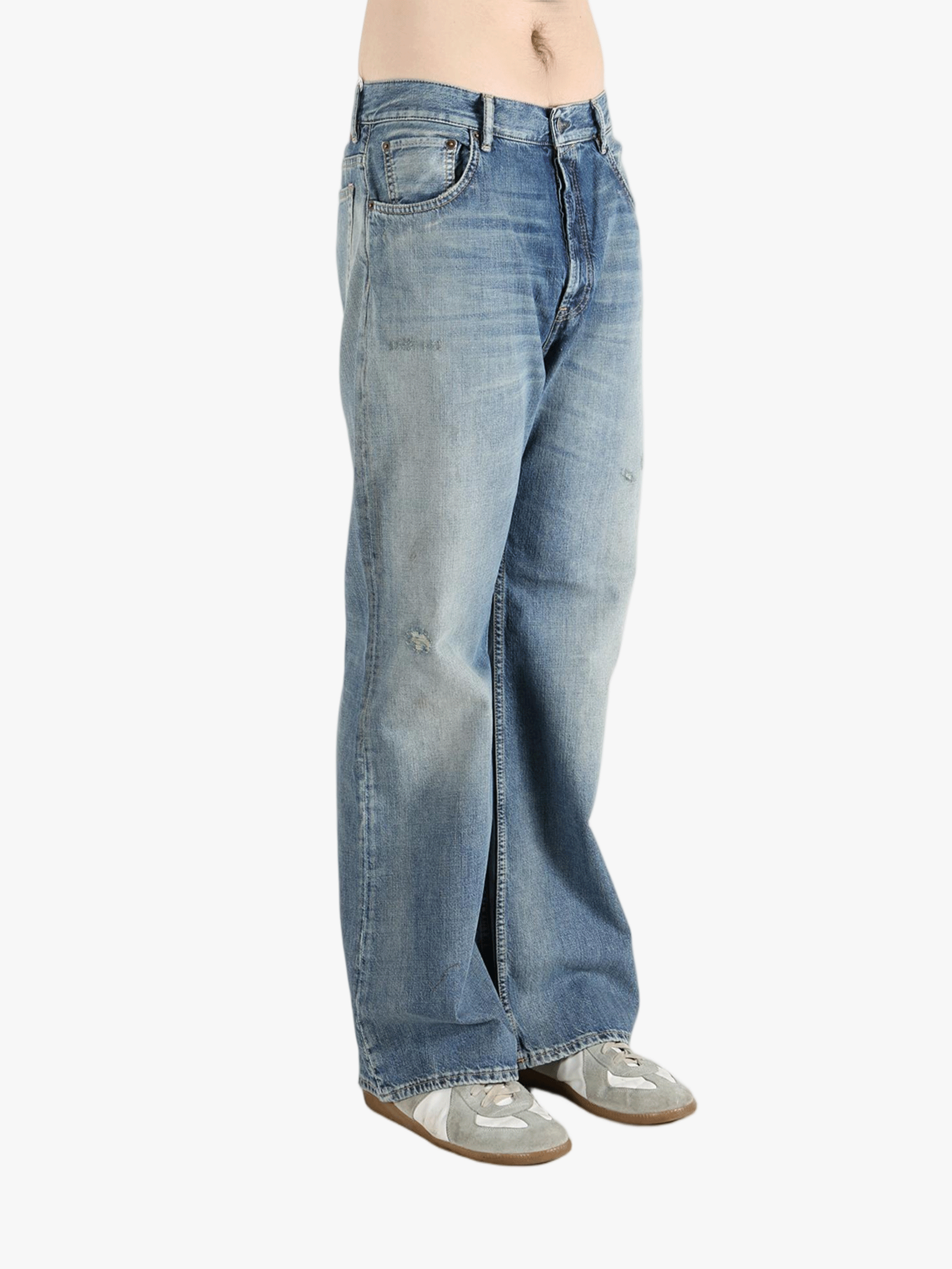 Blue jean worn by a person, showing the cow leather fit