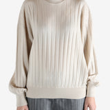 Grey knitwear worn by a person, showing the knitwear fit