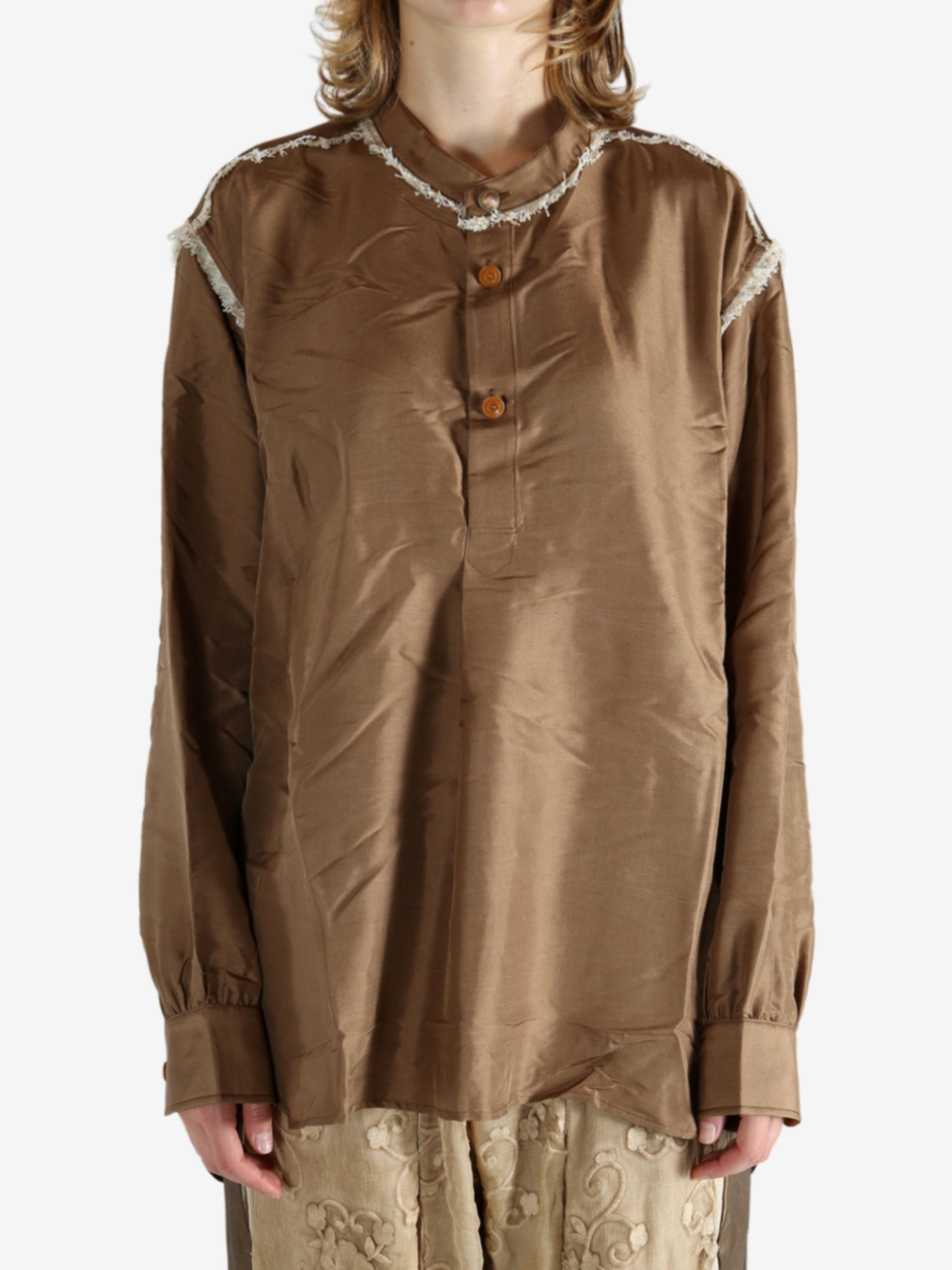 Brown shirt worn by a person, showing the shirt's fit