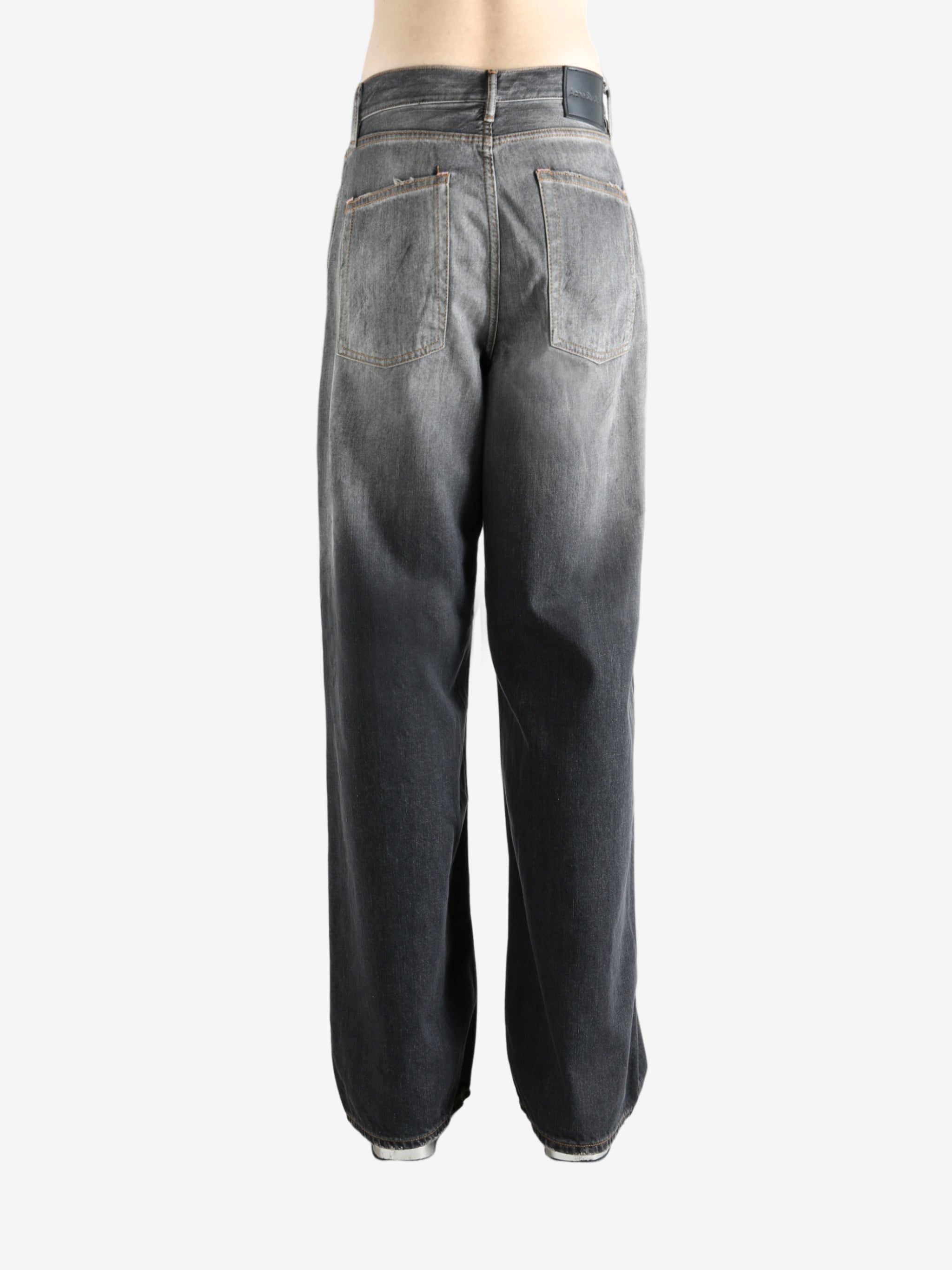 Black jeans worn by a person, showing the jeans' fit