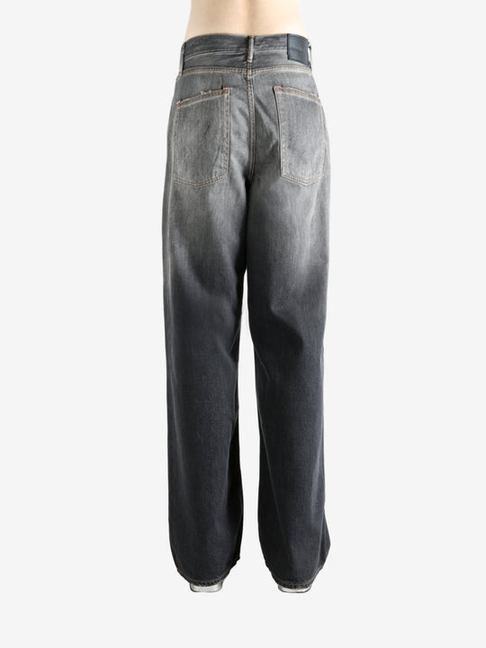 Black jeans worn by a person, showing the jeans' fit