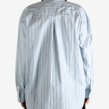 Blue shirts worn by a person, showing the shirts fit