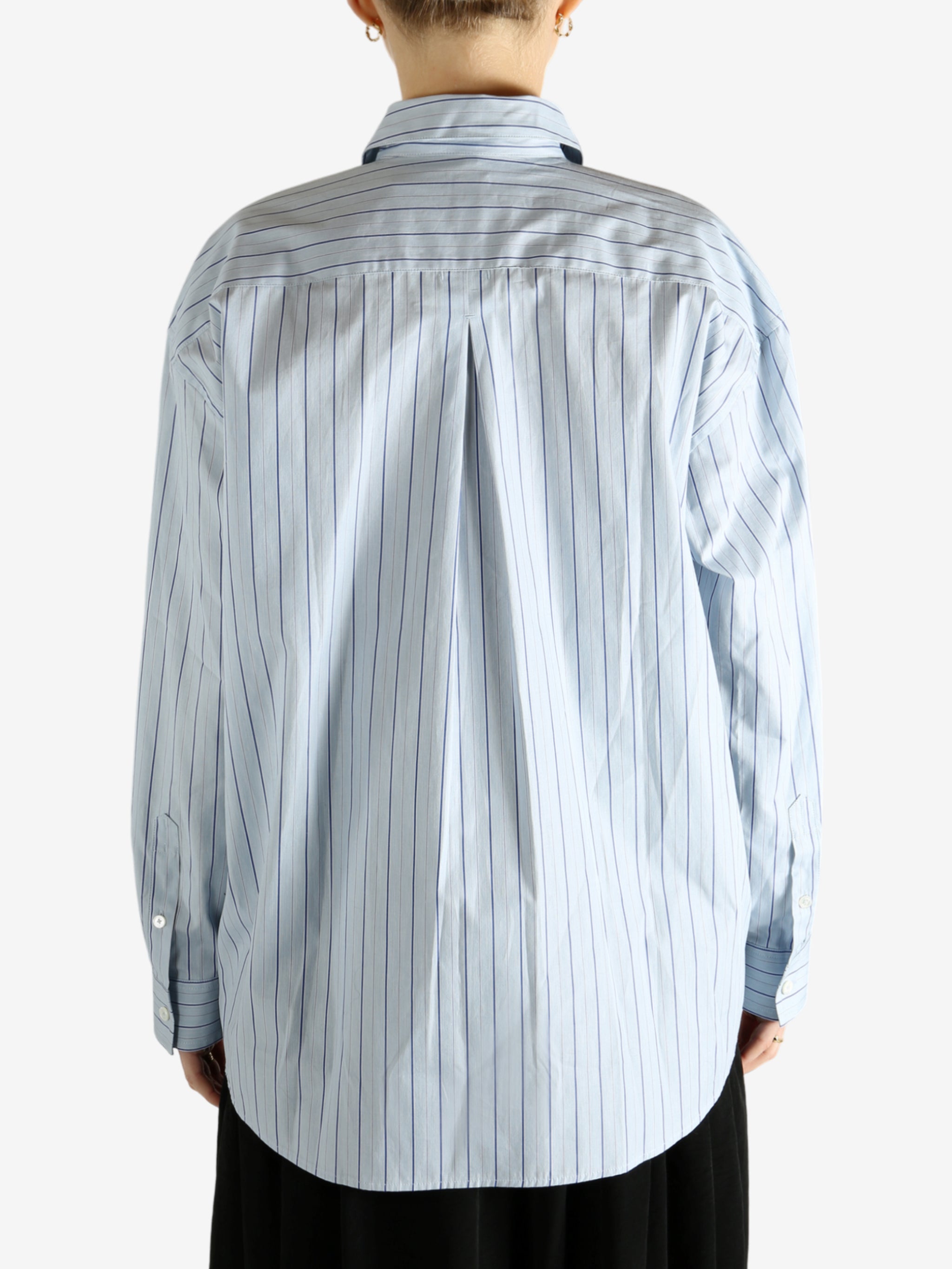 Blue shirts worn by a person, showing the shirts fit