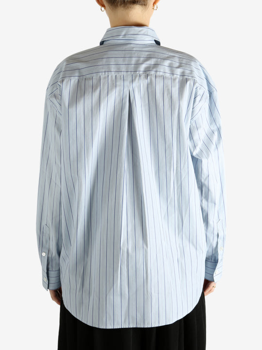 Blue shirts worn by a person, showing the shirts fit